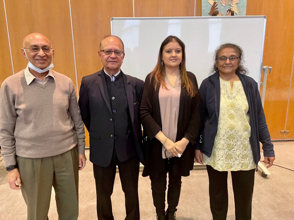 Image: Left to right, Hansraj Shah, Subhash Suthar, Bhavini Makwana & Usha Shah, standing in front of the white board, looking towards the camera and smiling.
